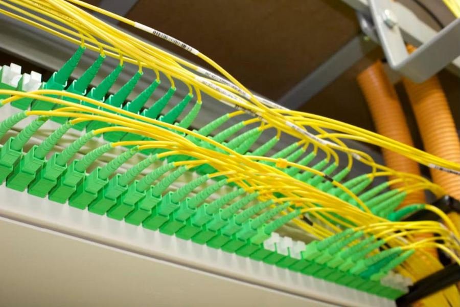 Optical patch panel with yellow pigtails and green SC/APC connectors