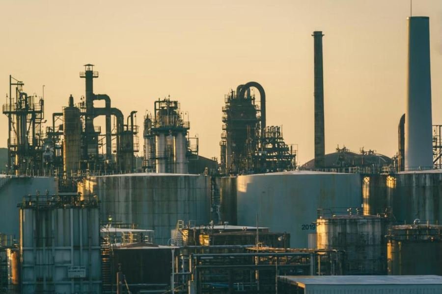 Industrial plant with storage tanks at sunset
